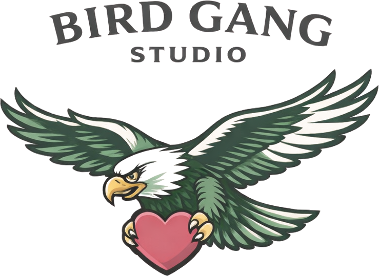 Bird Gang Studio logo: an eagle in flight holding a heart